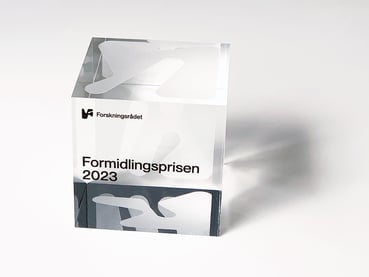 Pleksiglasskube med teksten Formidlingsprisen 2023 og Forskningsrådets logo.